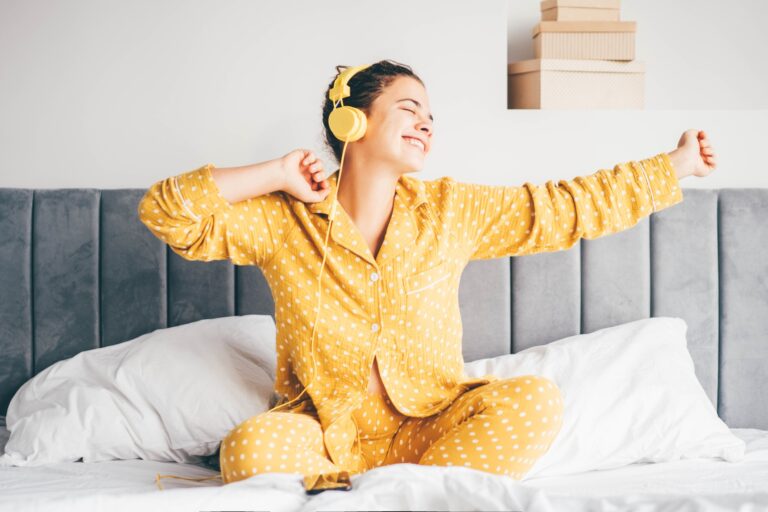 Woman relaxing at the bedroom at the morning.